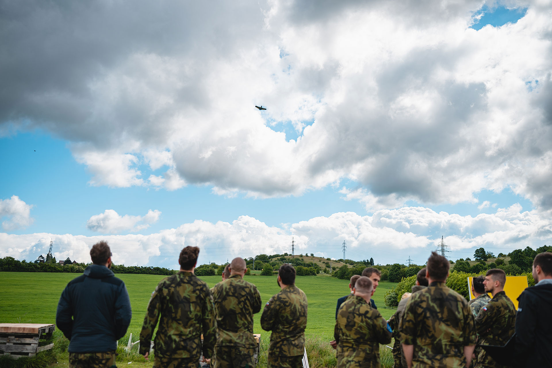 photo of the plane in the sky with people in army clothing below; Vrgineers.com